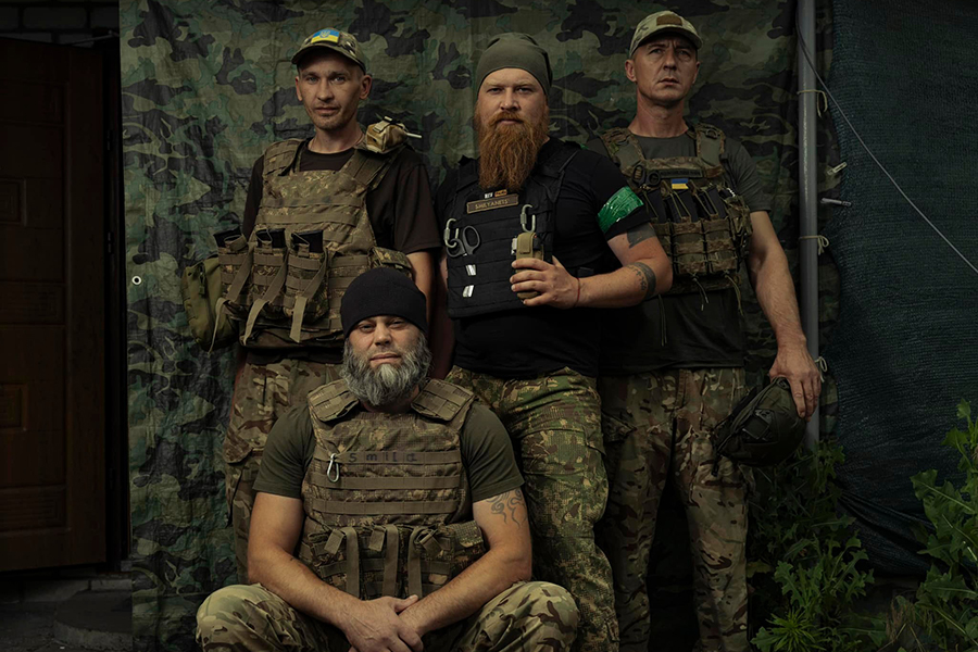 Soldier of a mortar unit of the Bureviy National Guard brigade - Maly, junior sergeant (left, baseball cap with a Ukrainian flag), Bohdan, call sign Smeliy, unit commander (center, standing), Sasha with a call sign Smela, 41 , division engineer (sitti